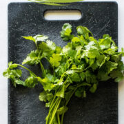 A bunch of cilantro on a cutting board