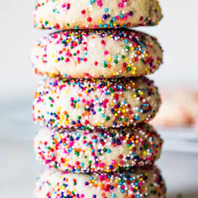 Sprinkle cookies stacked on top of one another.