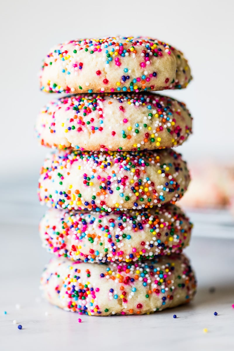 Sprinkle cookies stacked on top of one another.
