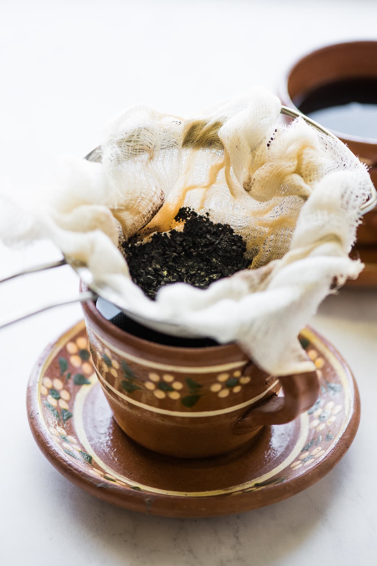 Coffee grounds being sifted from the cafe de olla.