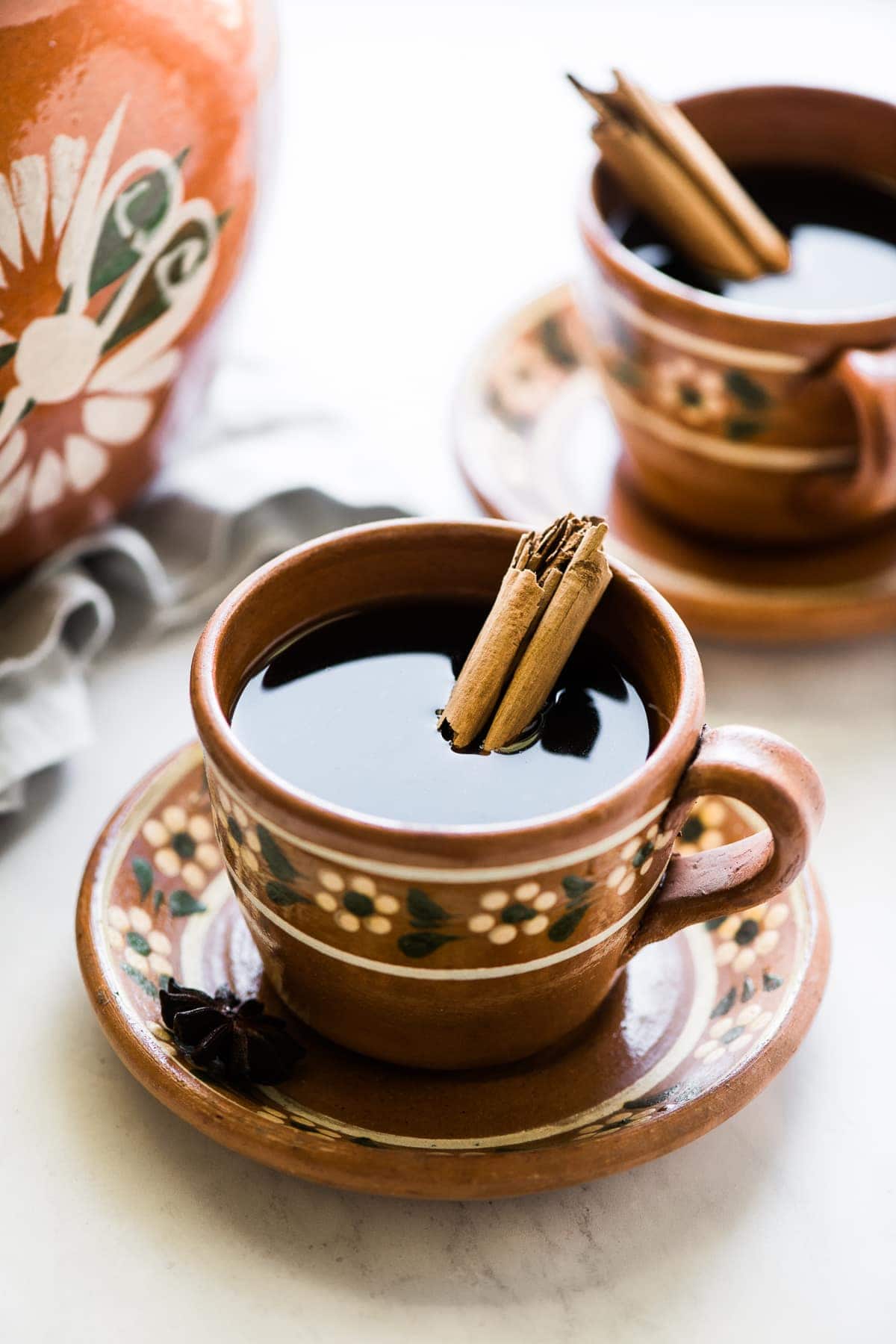 Cafe de olla (or traditional Mexican coffee) in a mug with a cinnamon stick.