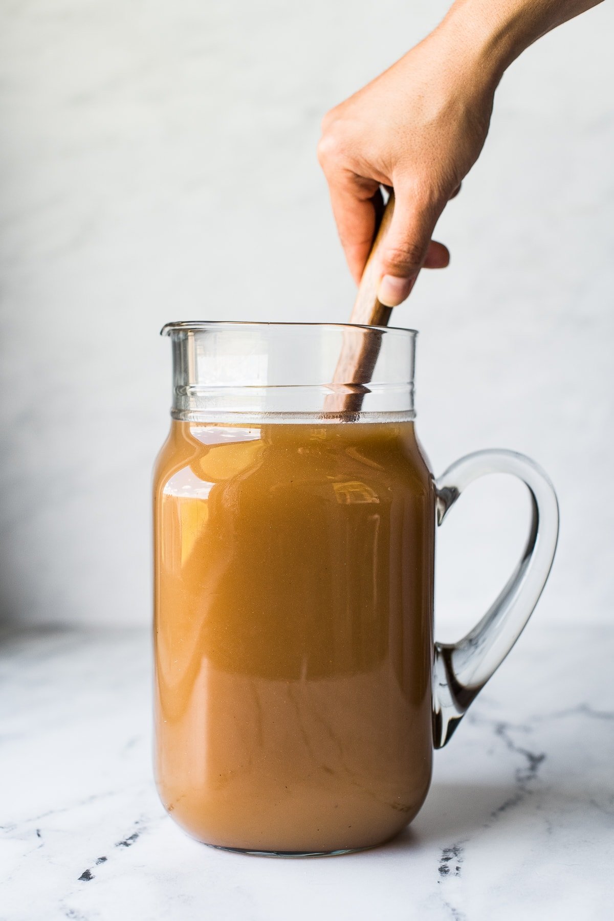 Mixing agua de tamarindo in a pitcher