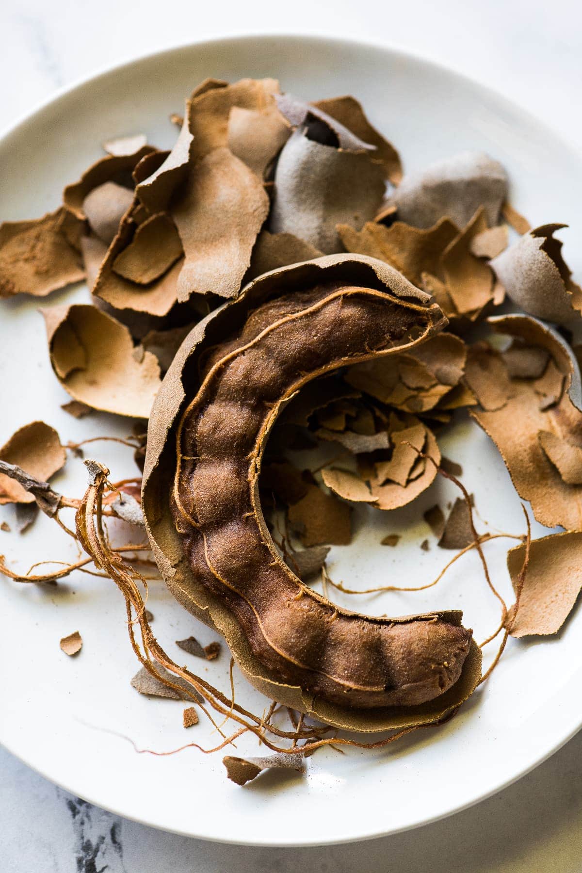 An open tamarind pod for agua de tamarindo.