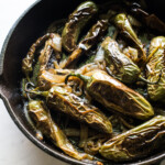 Chiles toreados in a skillet.