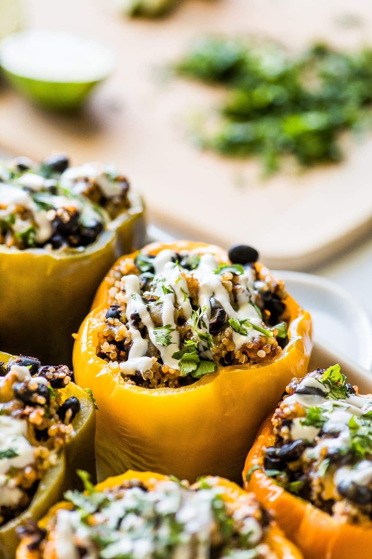 Stuffed peppers topped with sour cream and cilantro.