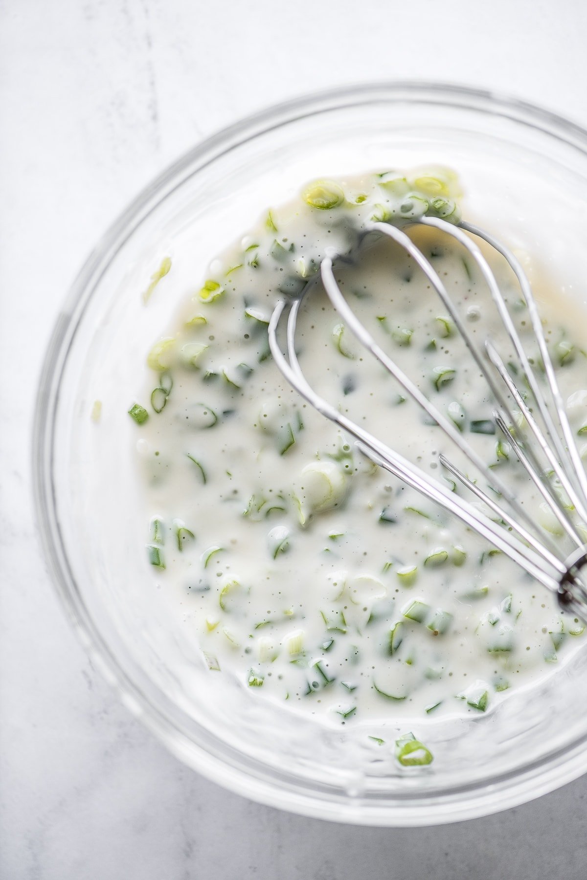 Jicama slaw dressing in a bowl.