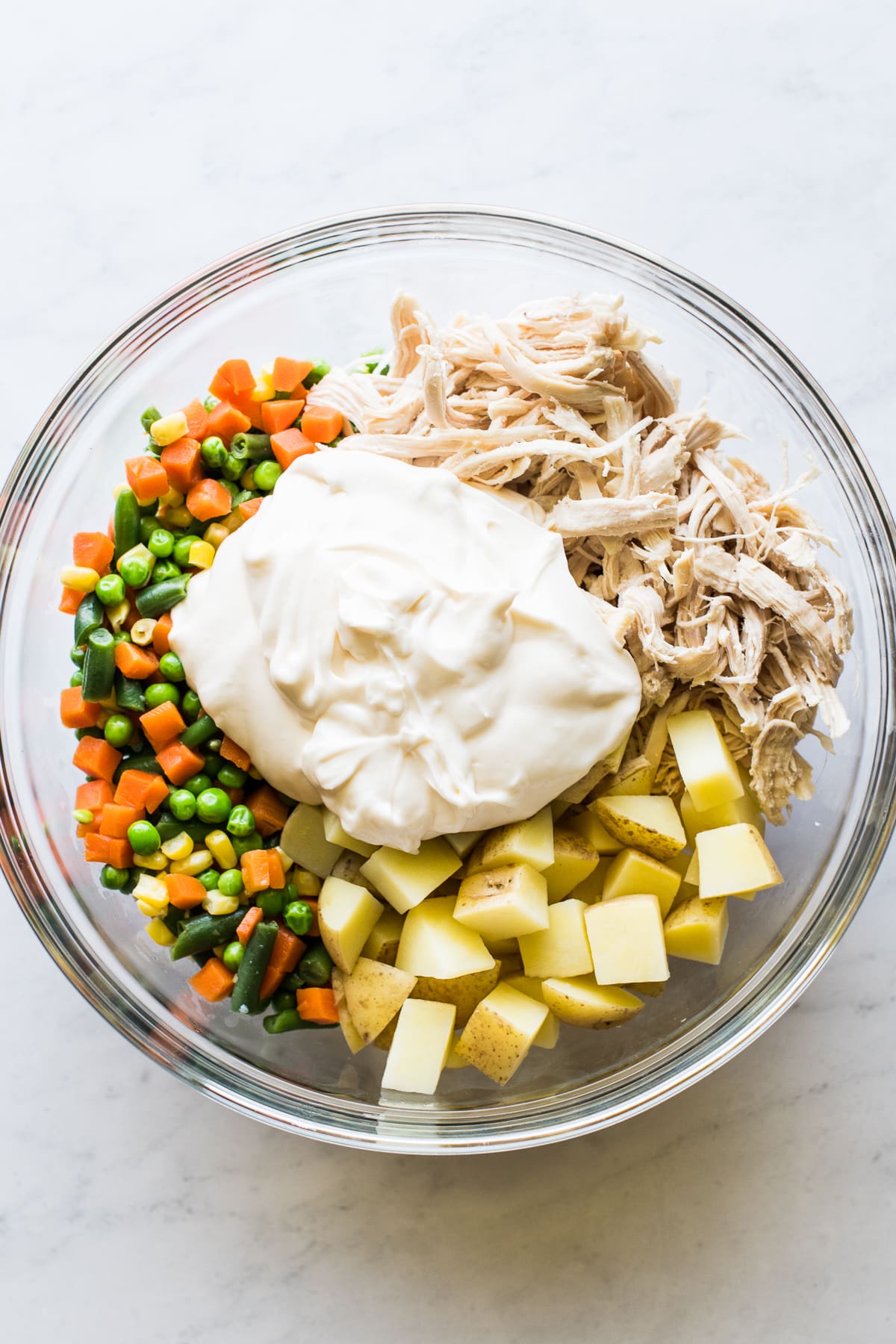 Ensalada de pollo ingredients in a bowl ready to be mixed together.