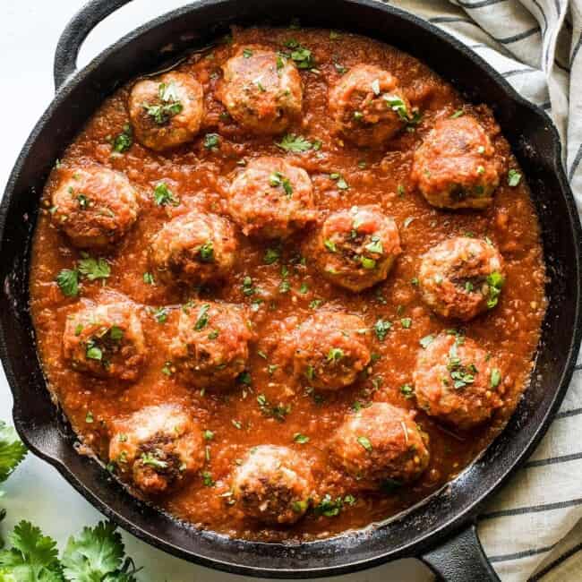 Mexican meatballs in a skillet with chipotle tomato sauce.