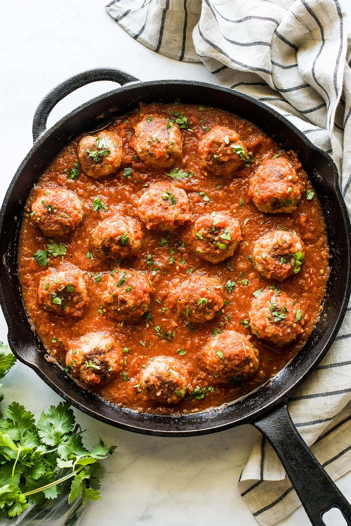 Mexican meatballs in a skillet with chipotle tomato sauce.