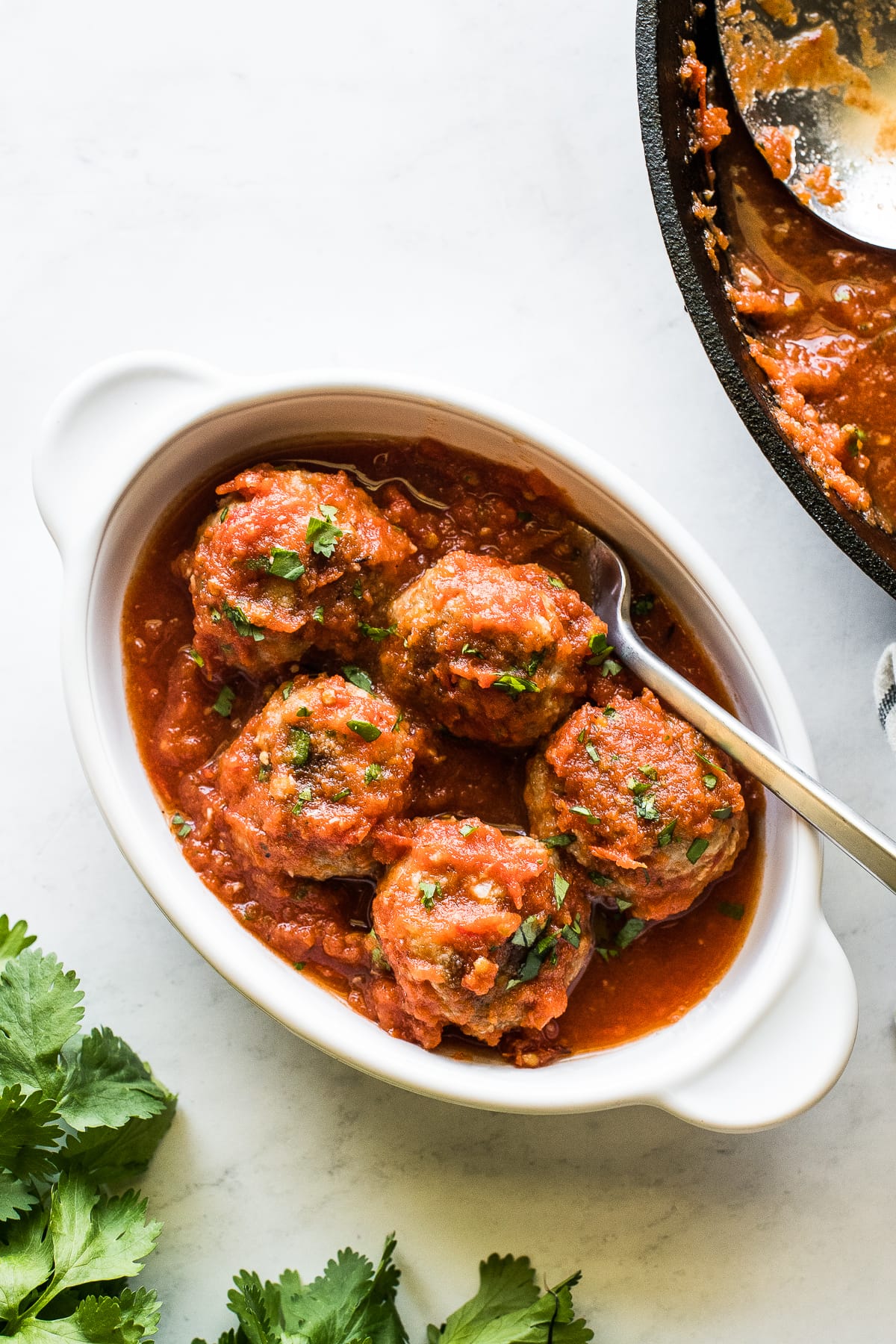 Mexican meatballs in a bowl with a fork.