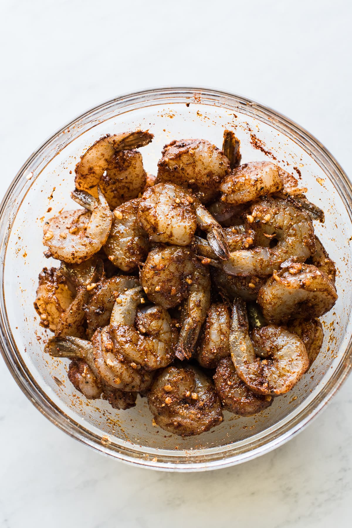 Seasoned shrimp in a bowl to make shrimp fajitas.