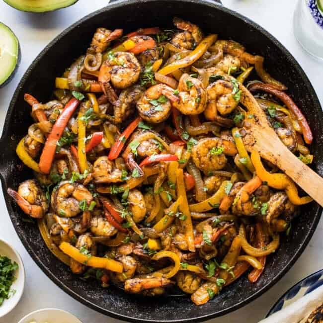 Shrimp fajitas in a skillet.