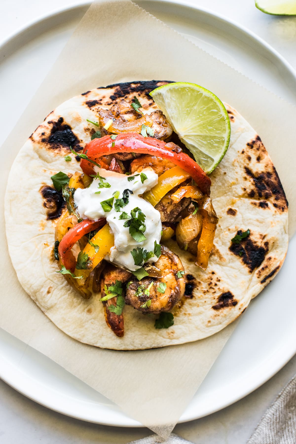 Shrimp fajitas in a flour tortilla.