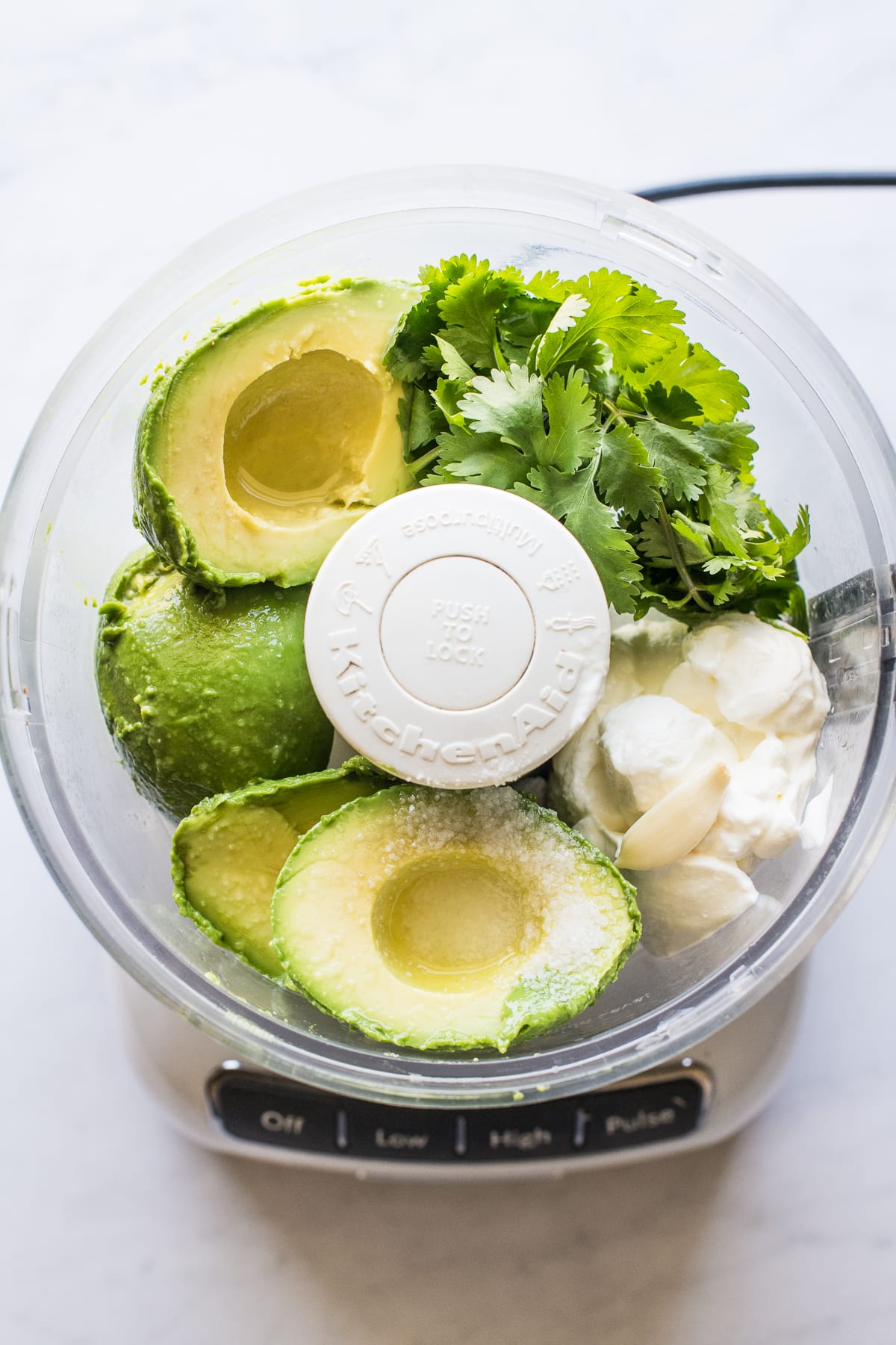 Avocado crema ingredients in a food processor.