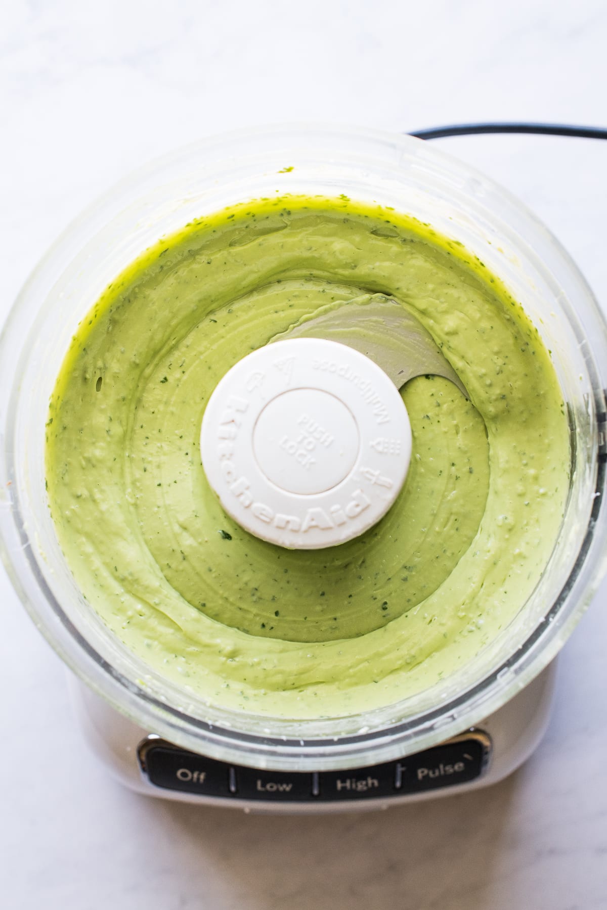 Avocado crema blended up in a food processor.