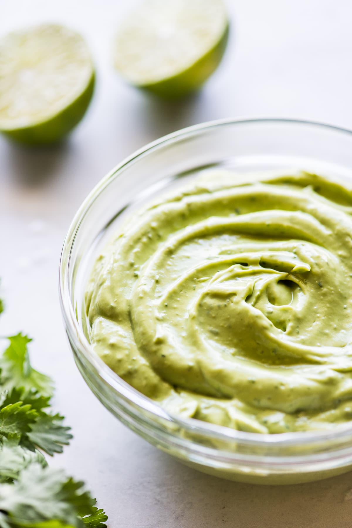 Creamy avocado crema in a clear bowl ready to eat.