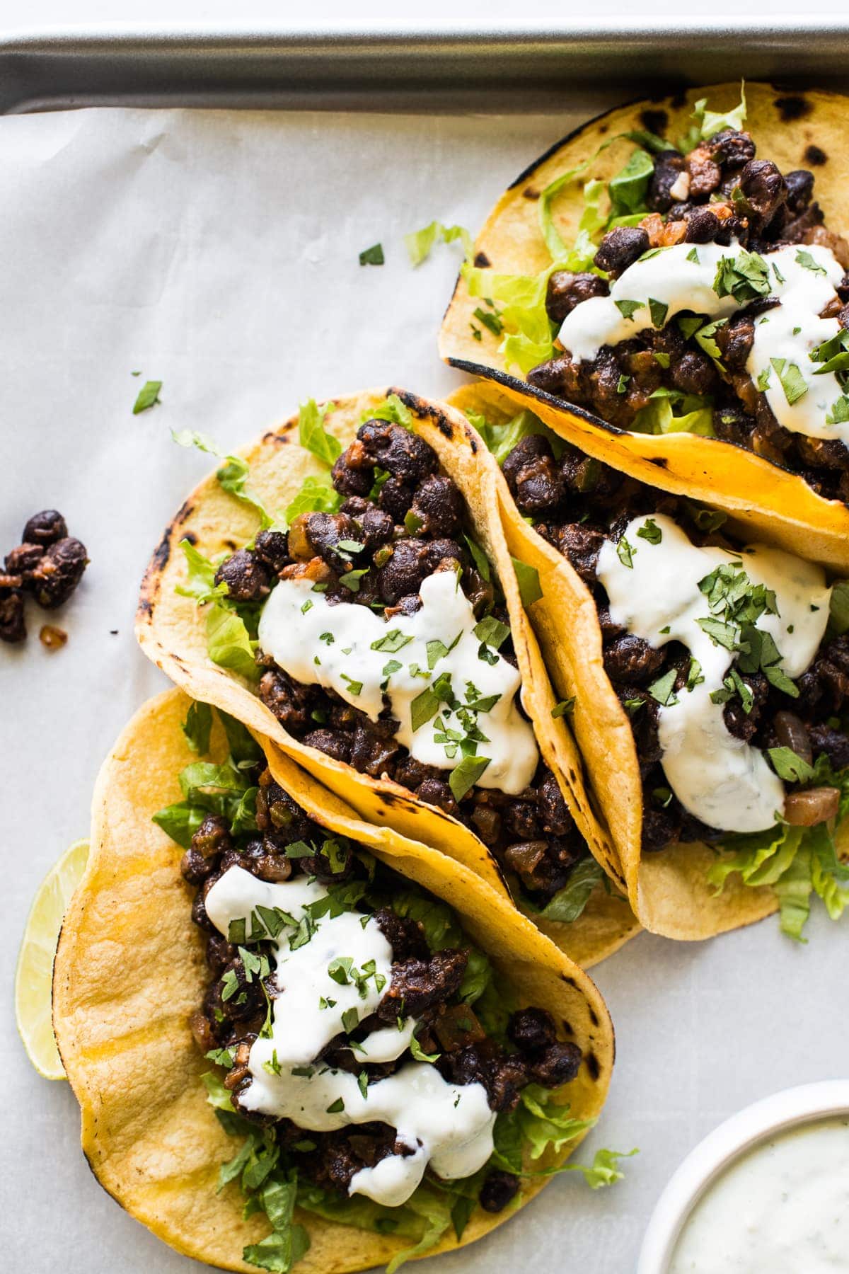 Black Bean Tacos topped with crema and chopped cilantro.