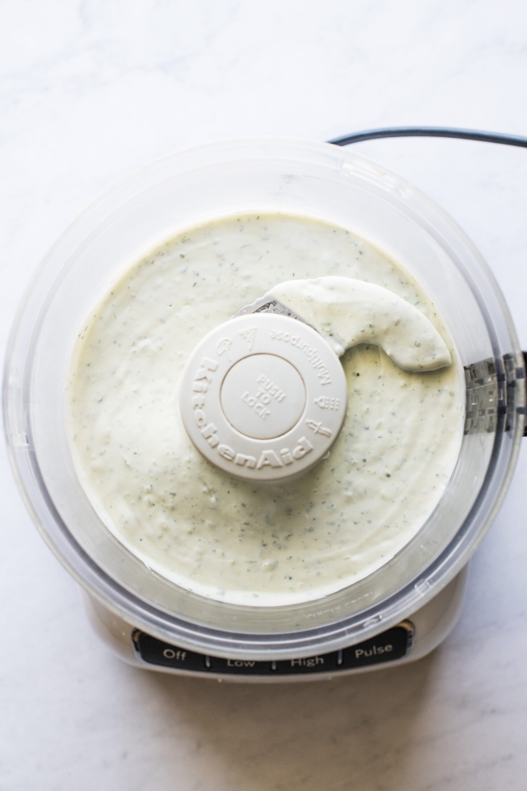 Cilantro lime crema in a food processor.