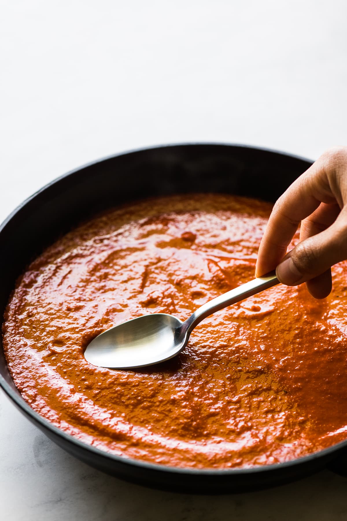Making a well with the back of a spoon in salsa.