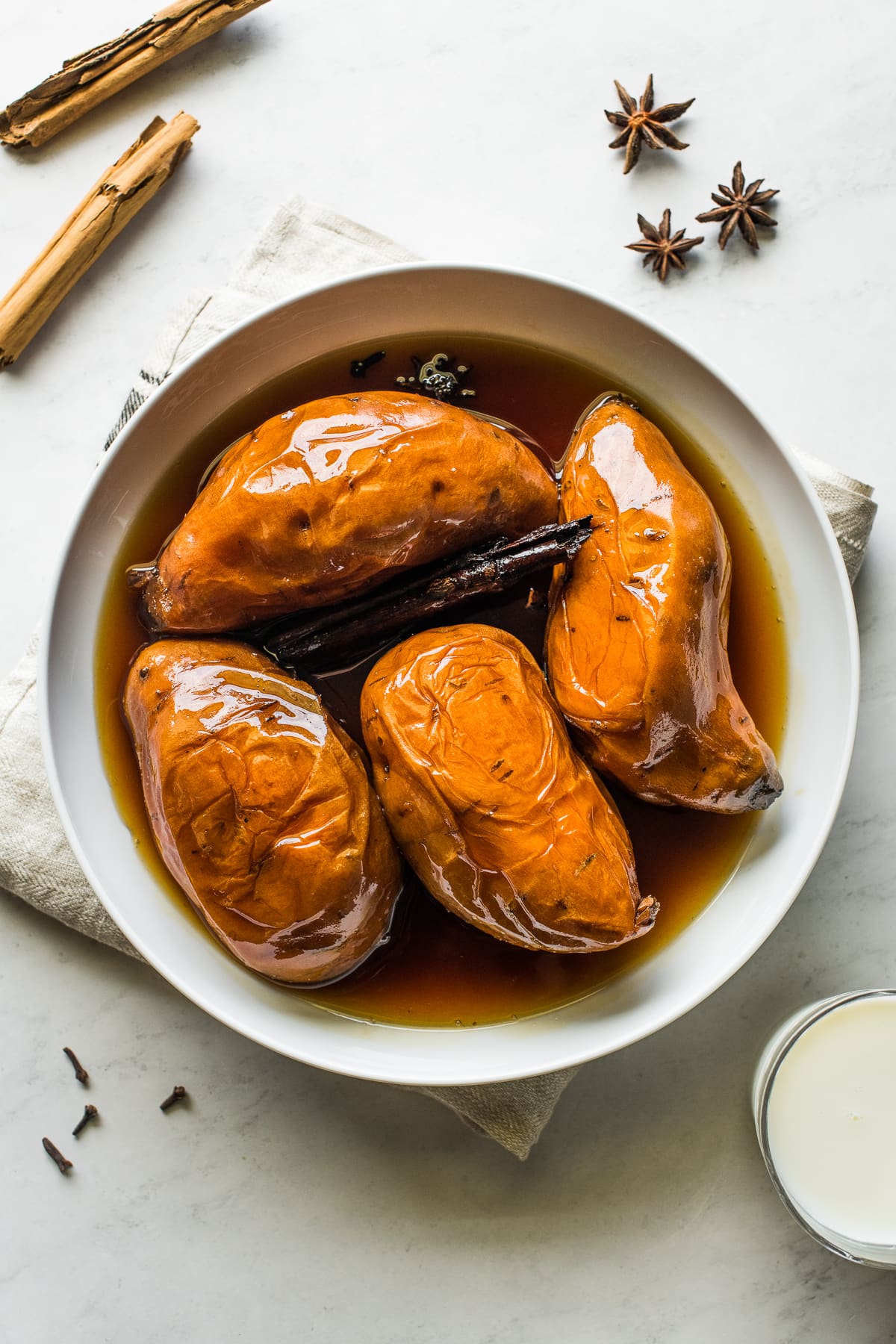 Camote enmielado in a large bowl with piloncillo syrup.