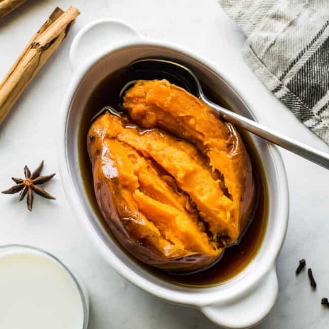 Cooked camote in a bowl with a spoon.