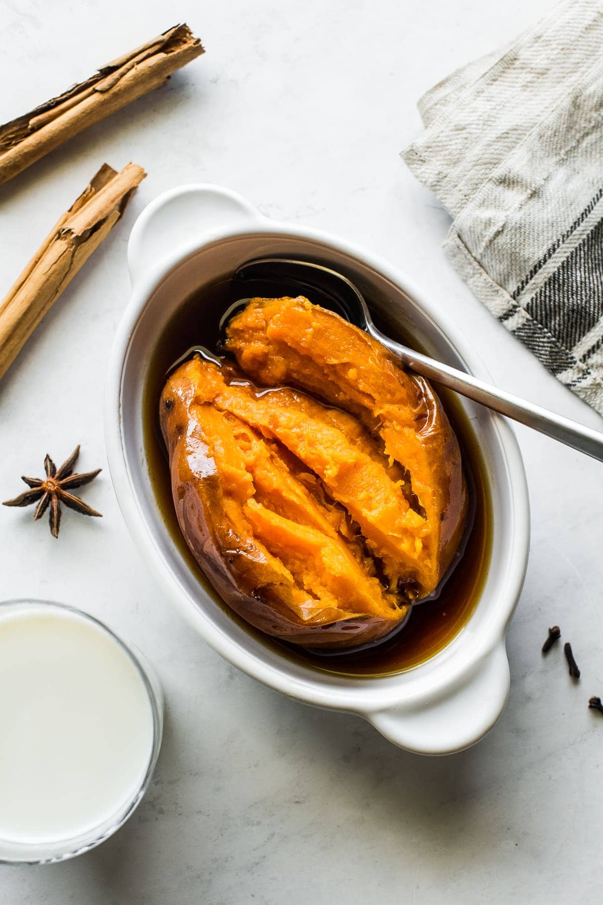 Cooked camote in a bowl with a spoon.