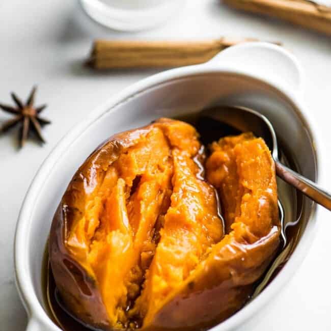 A cooked camote (or a Mexican candied sweet potato) in a bowl with piloncillo syrup.