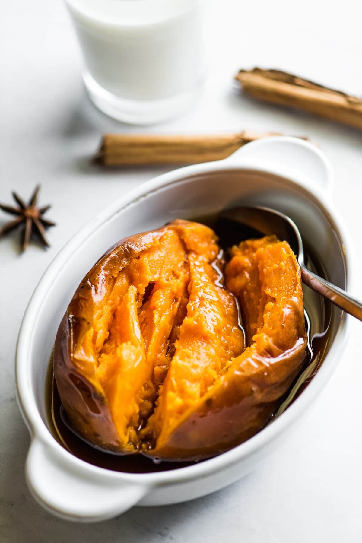 A cooked camote (or a Mexican candied sweet potato) in a bowl with piloncillo syrup.