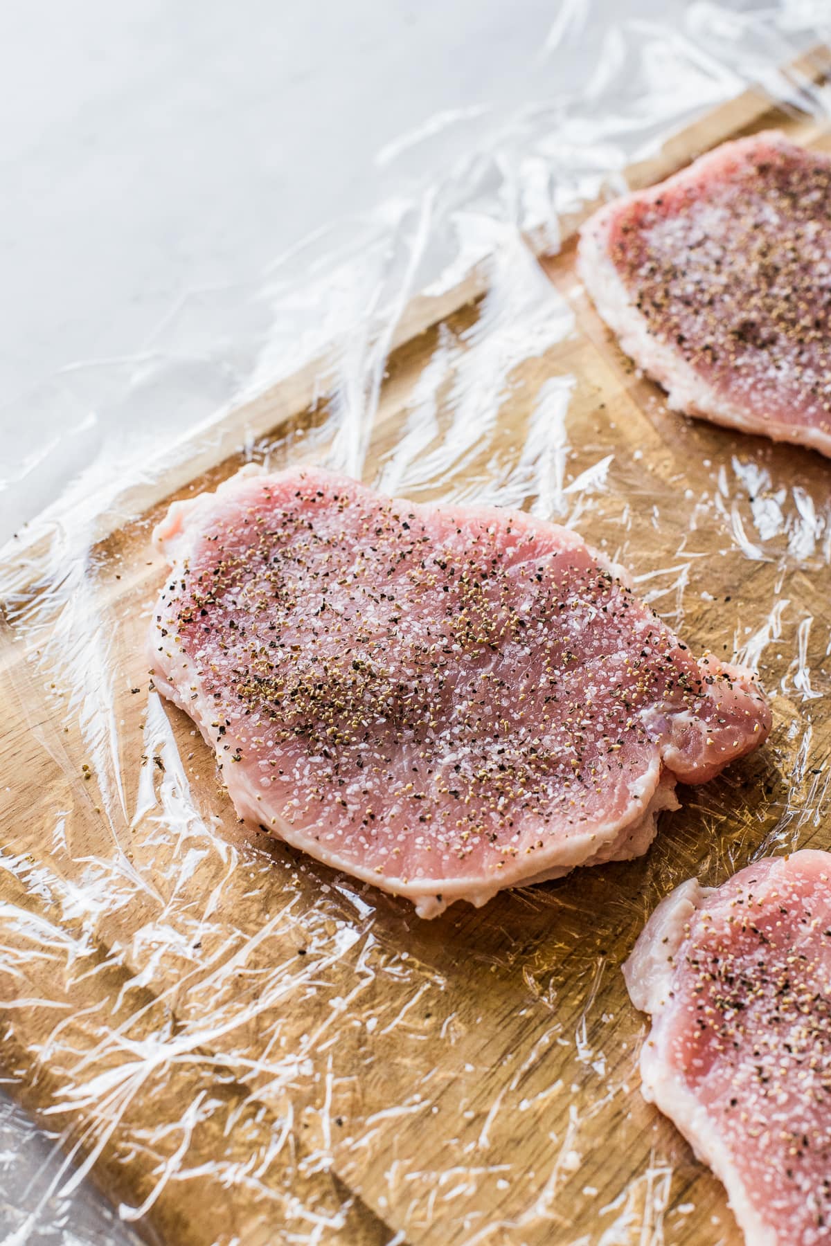 Pork chops seasoned with salt and pepper.