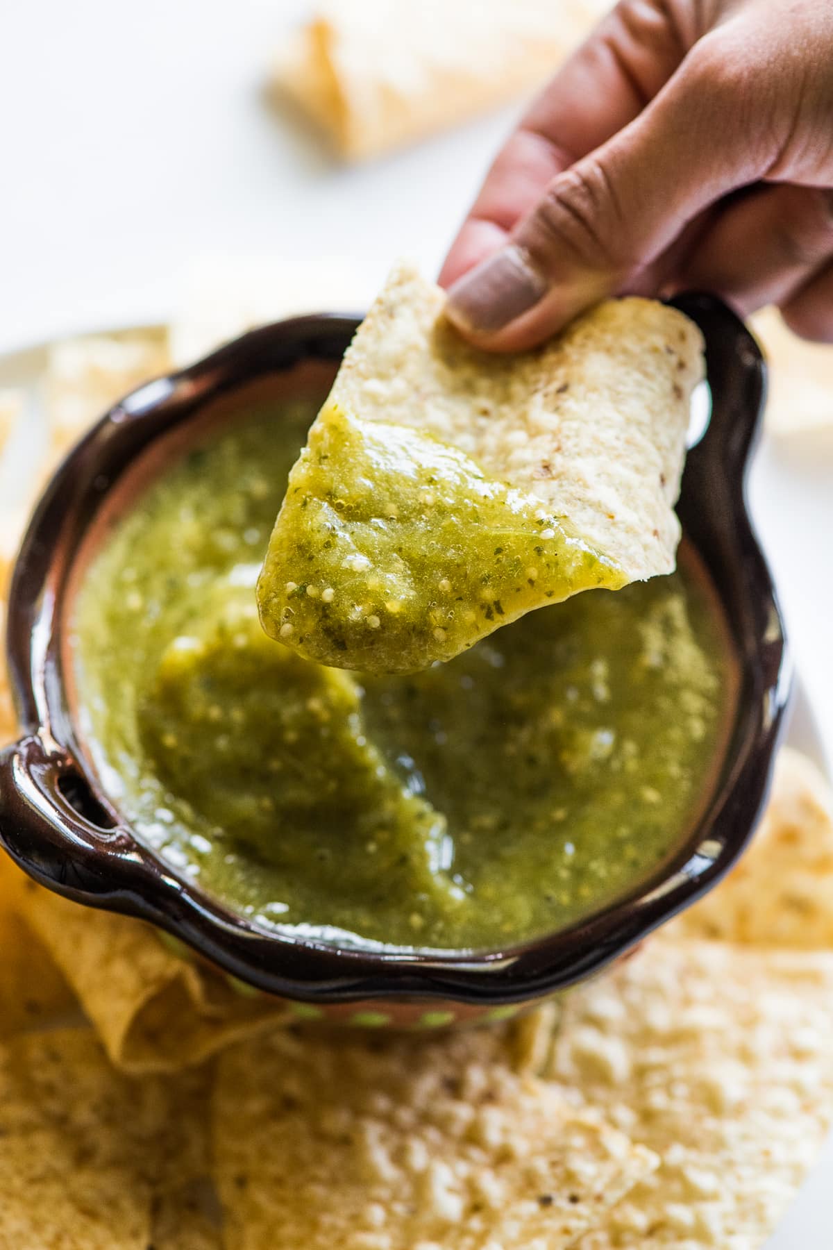 Salsa verde on a tortilla chip.