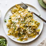 Chilaquiles verdes on a white plate.