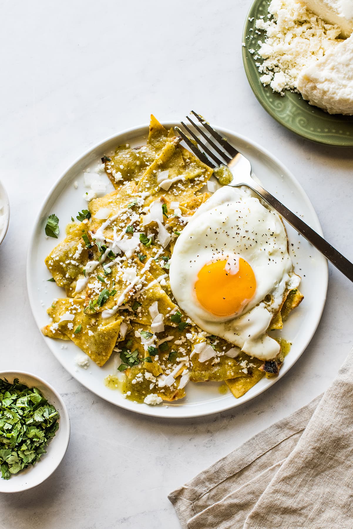 Chilaquiles Verdes topped with a sunny side up egg.