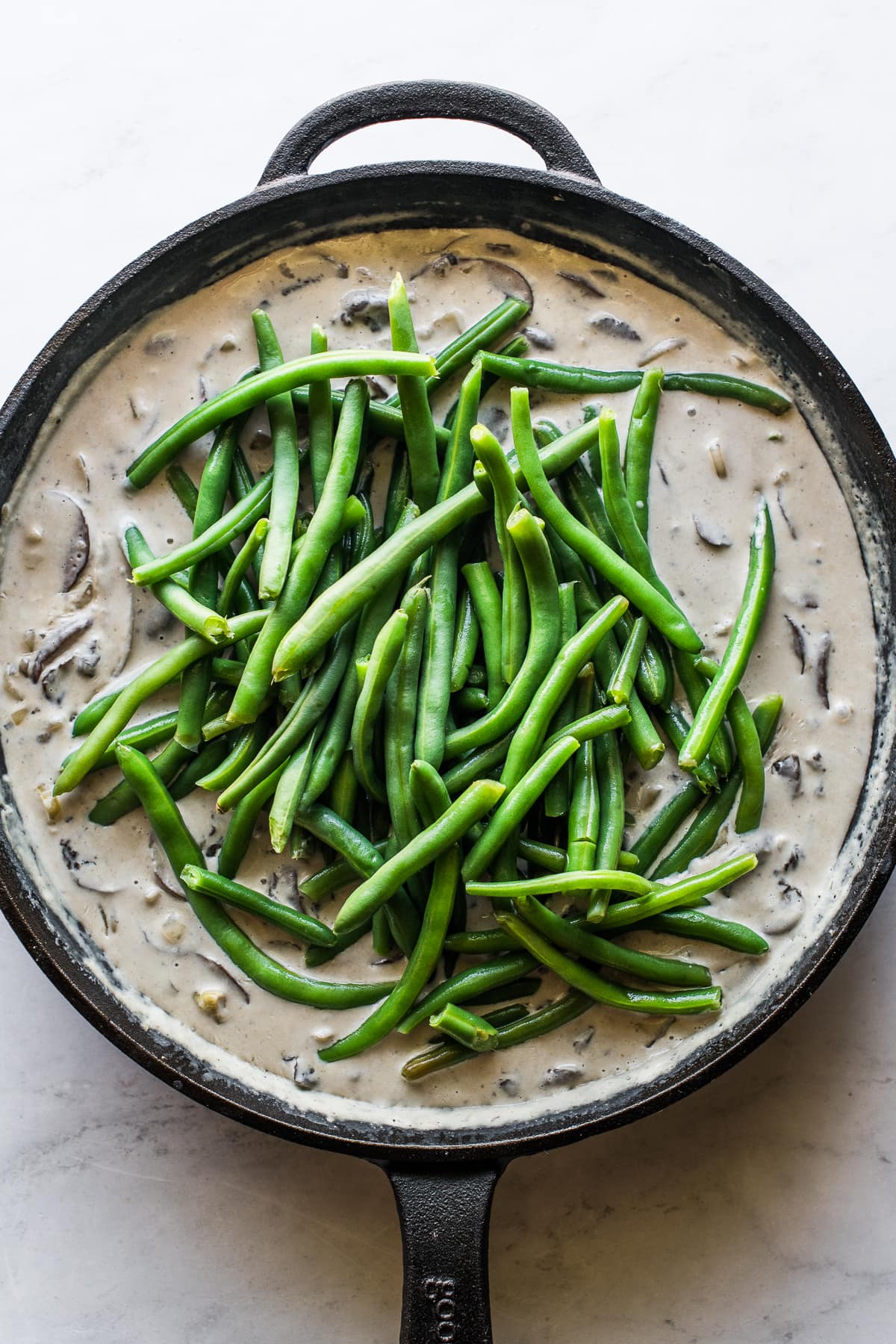 Fresh green beans in a gravy cream sauce for green bean casserole.