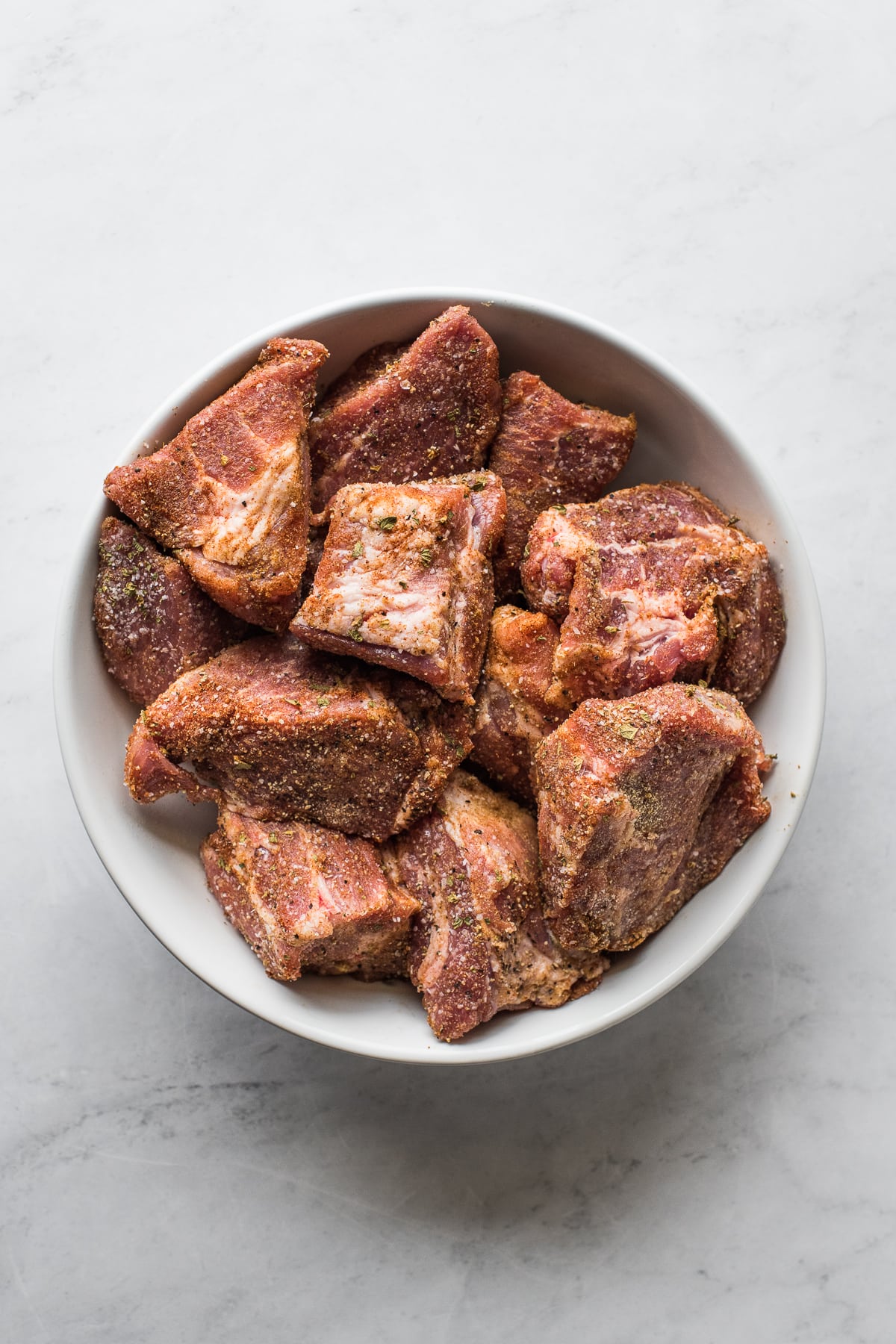 Seasoned pork shoulder cut into large chunks.