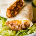 A bean and cheese burrito with melted cheese and refried beans.