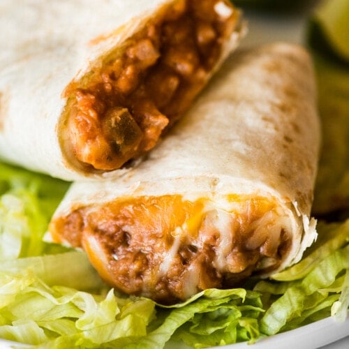 A bean and cheese burrito with melted cheese and refried beans.