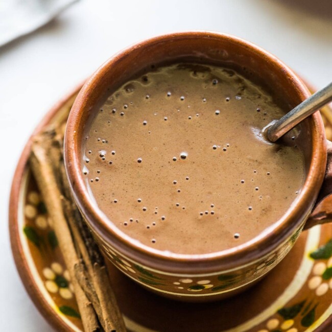 A thick and creamy champurrado in a Mexican mug.