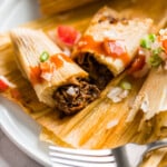 An Instant Pot Pork Tamale cut in half to show the center.