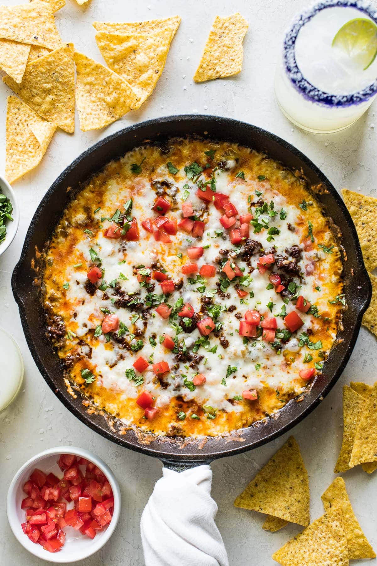 Queso fundido in a skillet with crumbled chorizo.