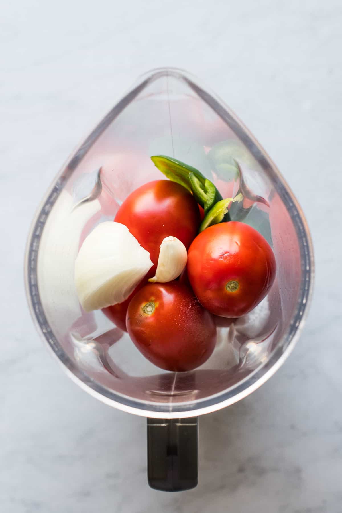 Tomatoes, onion, garlic, and jalapeño in a blender.