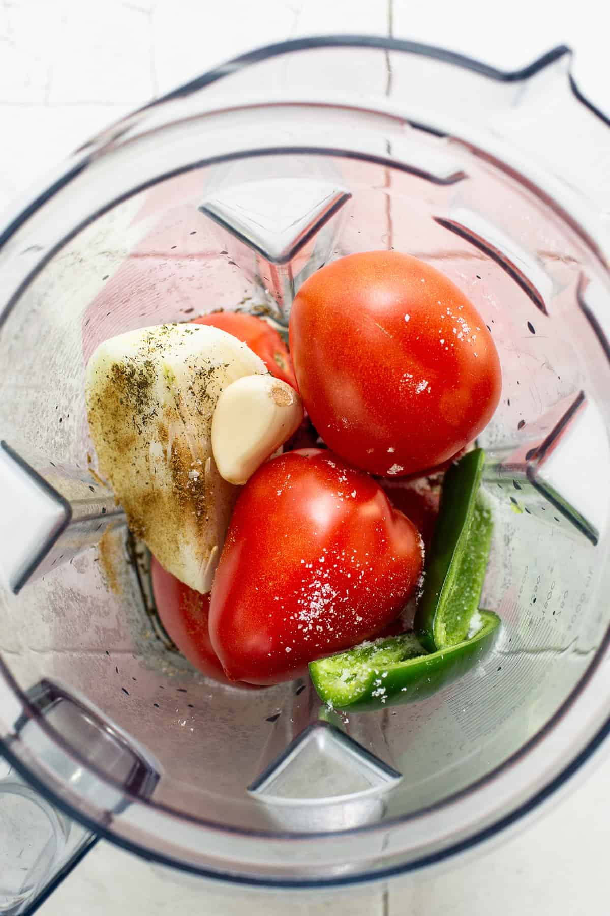 Ingredients for the entomatada sauce in a blender before blending.