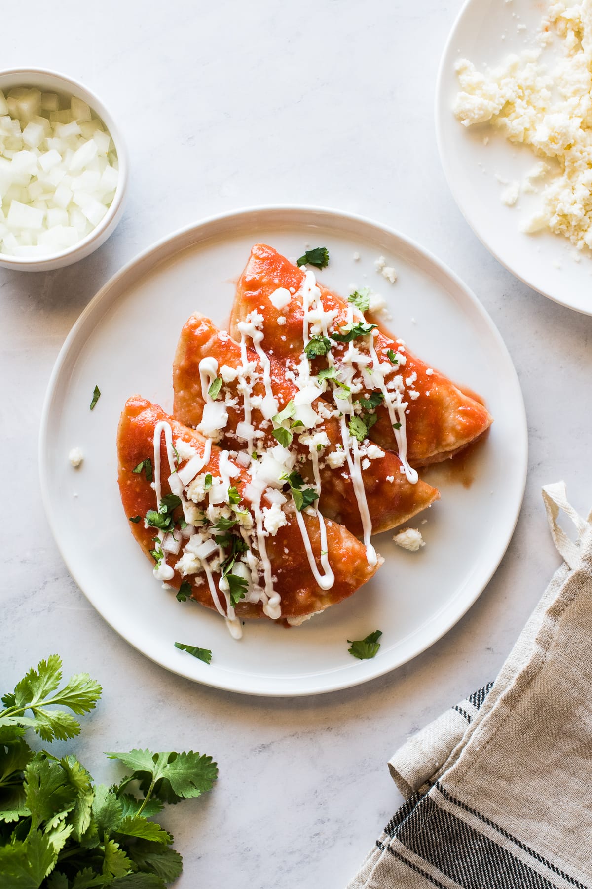 Entomatadas on a plate stacked against one another.