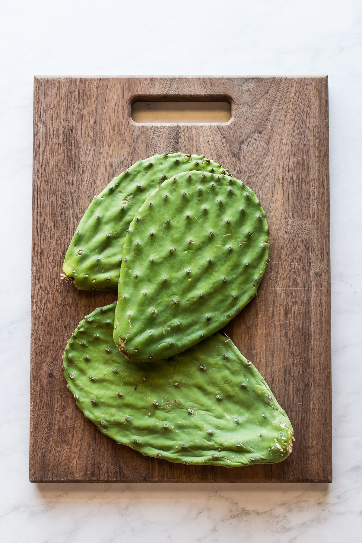 Nopales (cactus paddles) on a cutting board