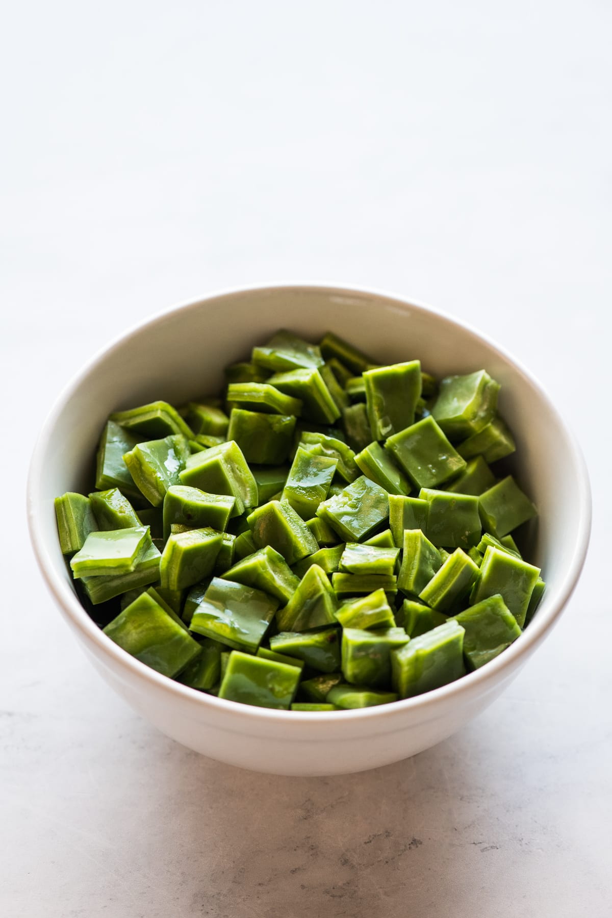 A bowl of diced nopales (cactus paddles) ready to be cooked.