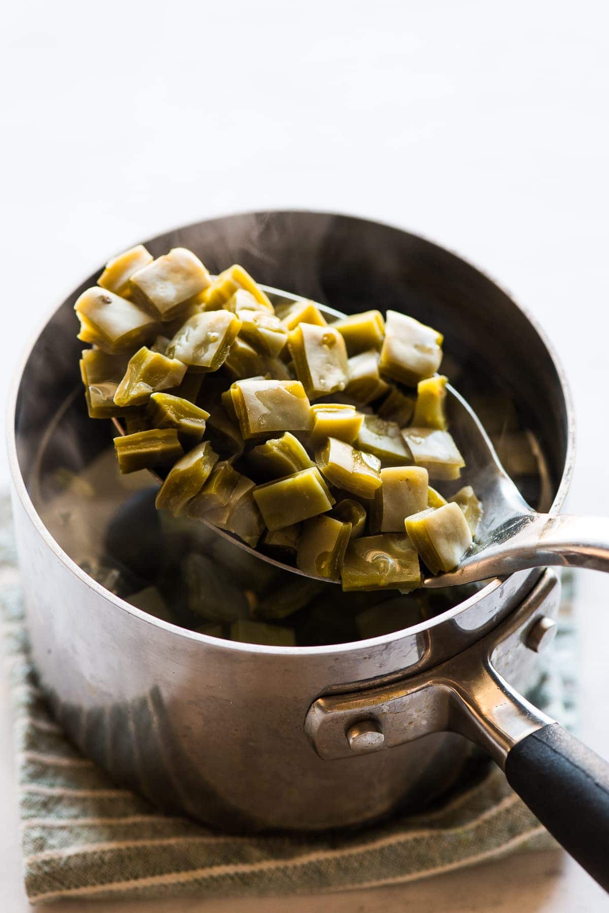 Cooked nopales on a spoon.