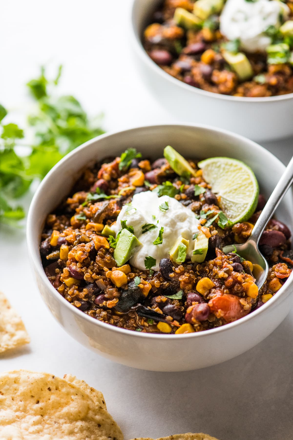 A bowl of vegetarian black bean and quinoa chili with a spoon.