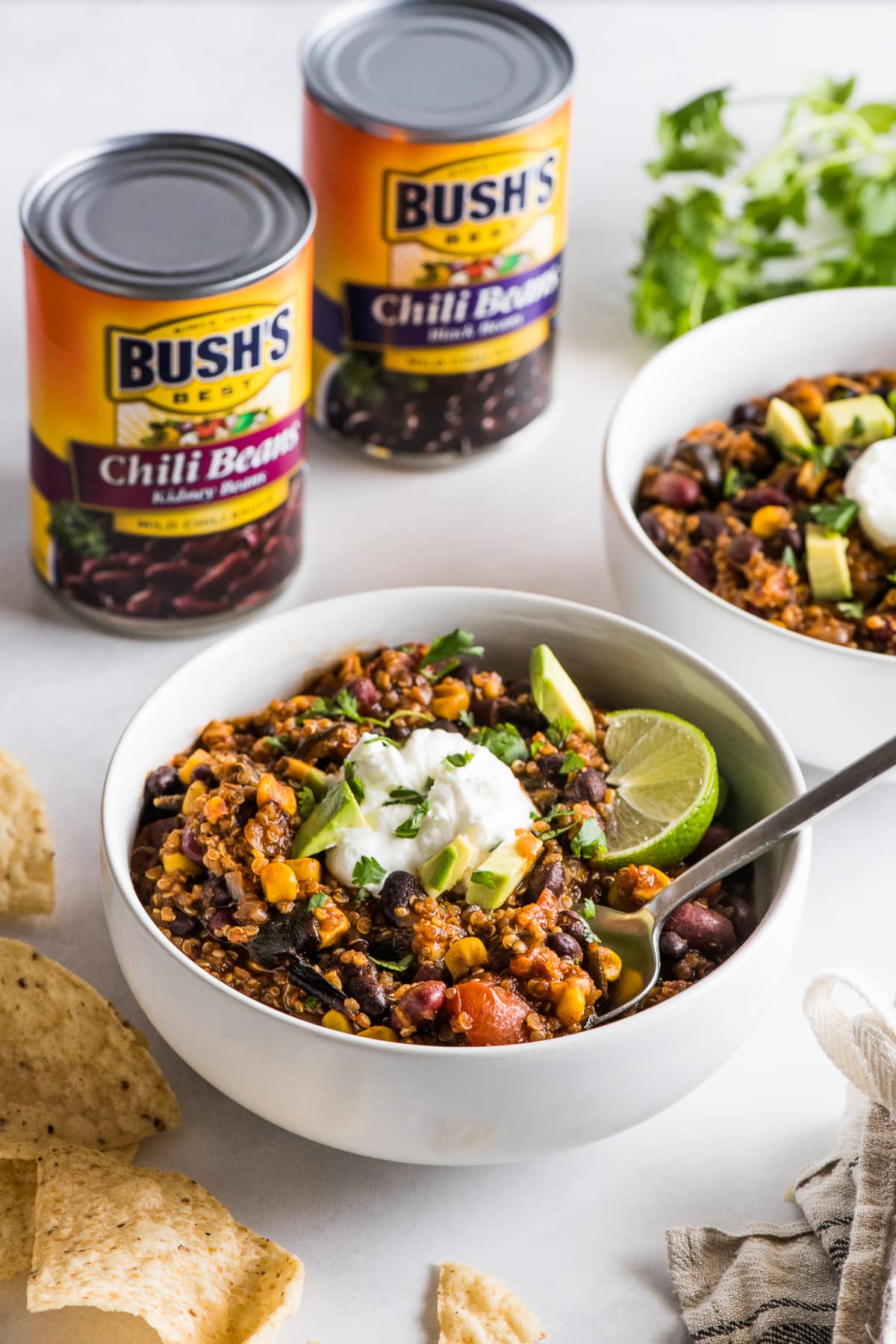 A bowl of quinoa black bean chili next to some tortilla chips.