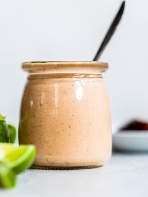 Chipotle ranch dressing in a jar with a spoon in it.