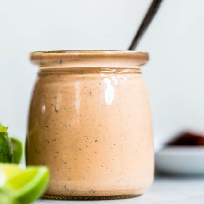 Chipotle ranch dressing in a jar with a spoon in it.