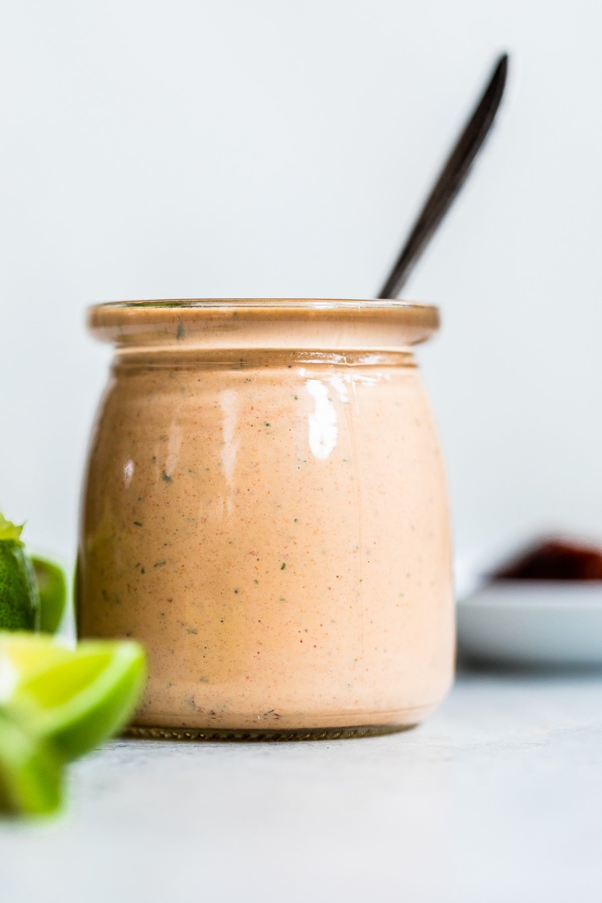 Chipotle ranch dressing in a jar with a spoon in it.